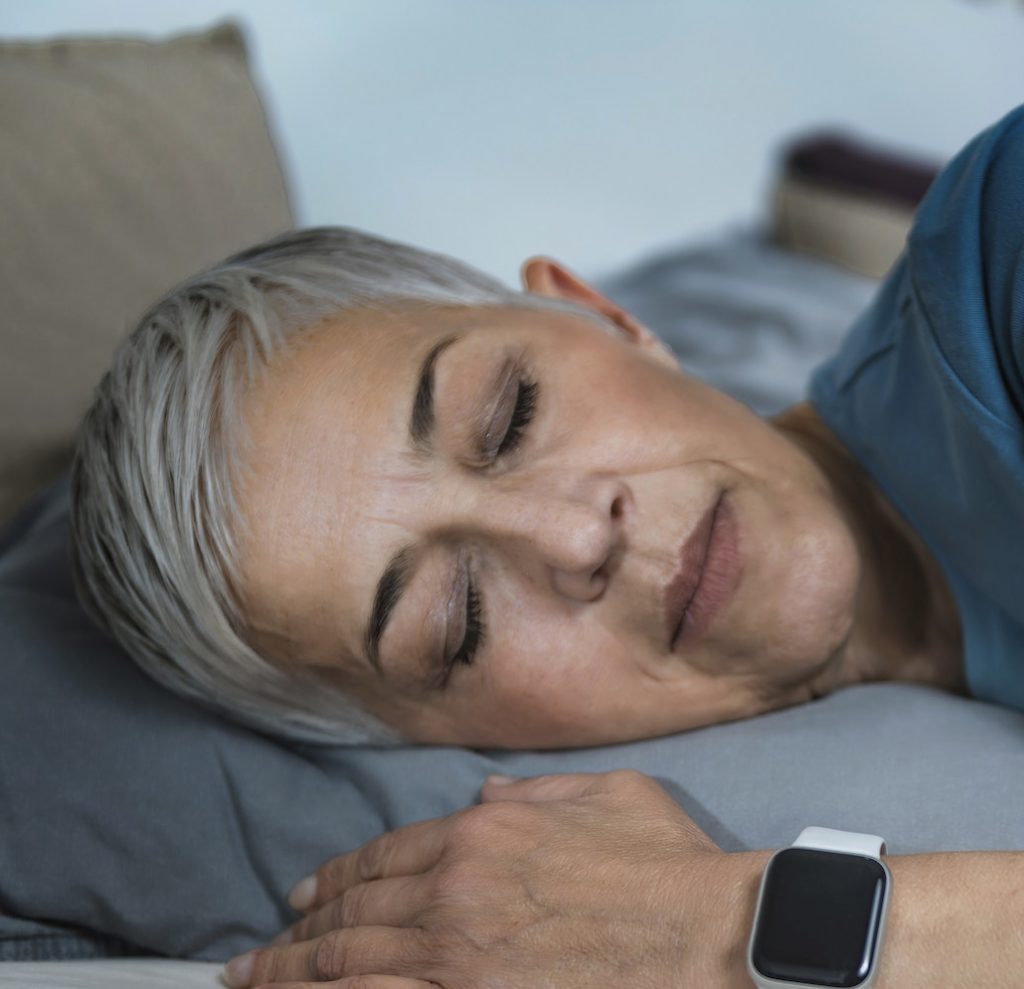 Sleep Apps - Tech-savvy Senior Woman Sleeping in Bed